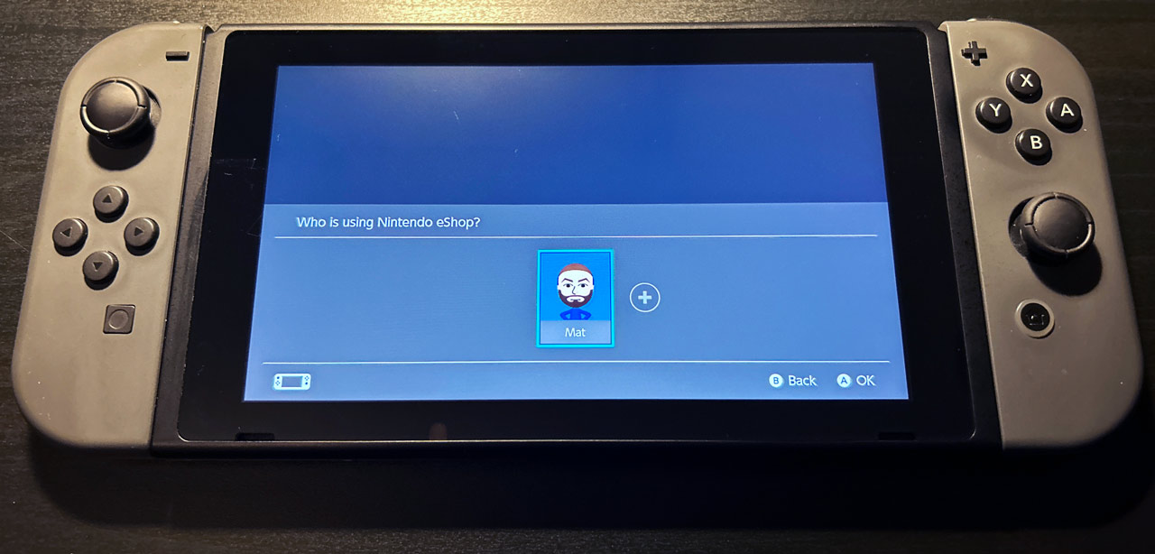 A Nintendo Switch showing the user selection screen when opening the store
